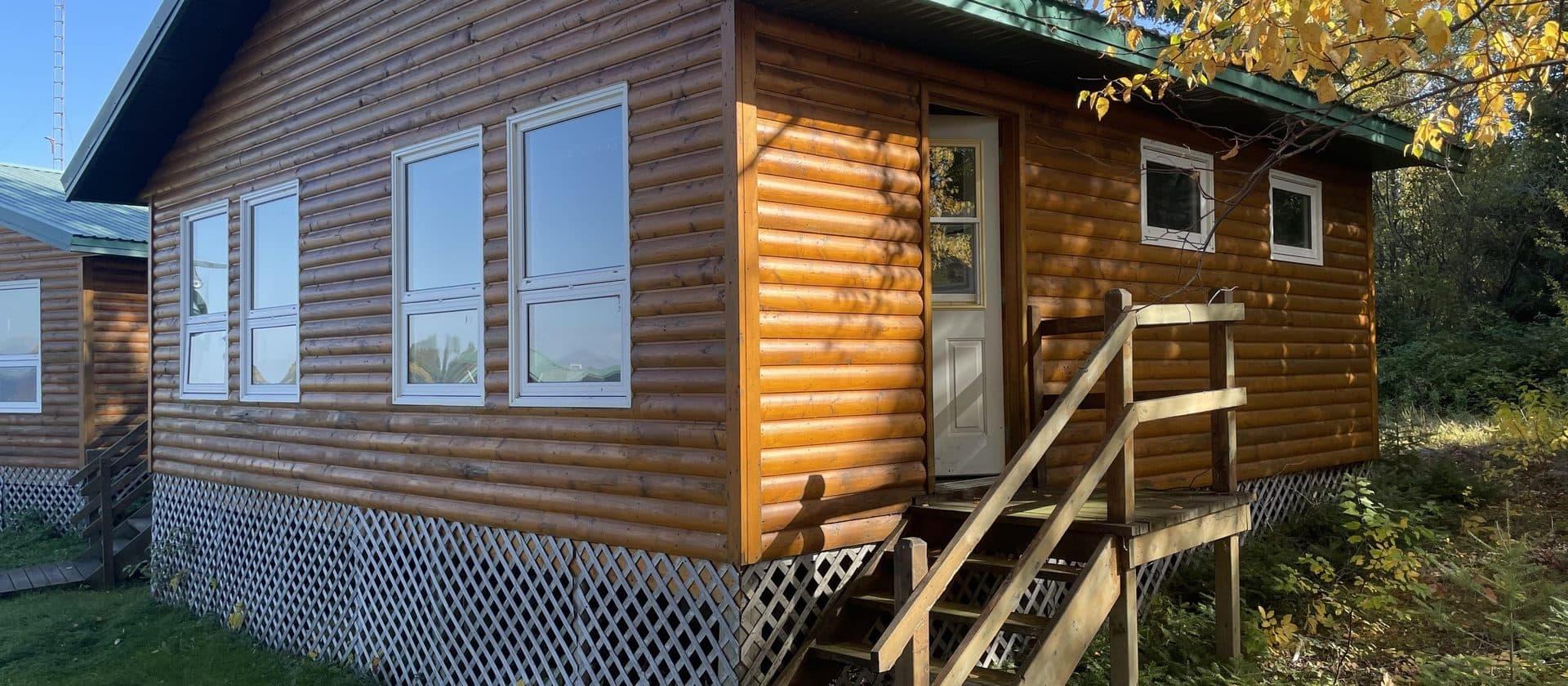 Dogskin Lake Lodge dock with boats and floatplane at golden hour